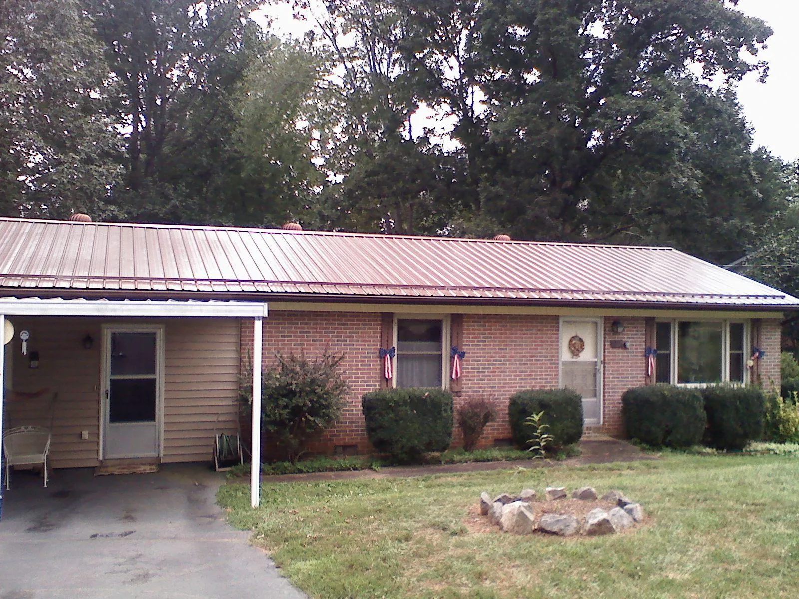 Bronze metal roof and carport on a brick ranch home — Roof Repair work by our crew in Lake Zurich